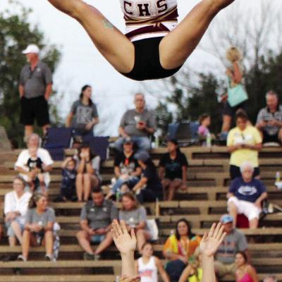 Saydee Starnes, Bri Denney and Gracie DeLuna throw Addison Newcomb into the air and catch her during Clinton’s home football game against Kingfisher. CDN | Emily Stephens Clinton cheer prepares for regionals