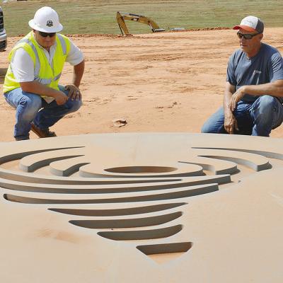 Project Manager Zach Whedbee, left, and Streets Maintenance Supervisor Craig Tucker look at the tornado form mold that will be used to decorate one of the future bridges being built on Interstate 40. CDN | Christian Jacobsen