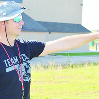 New Corn Bible Academy AD and coach Zach House instructs athletes during their summer pride football sessions. CDN | Sam Goodwyn Crusaders find new athletic leadership in House