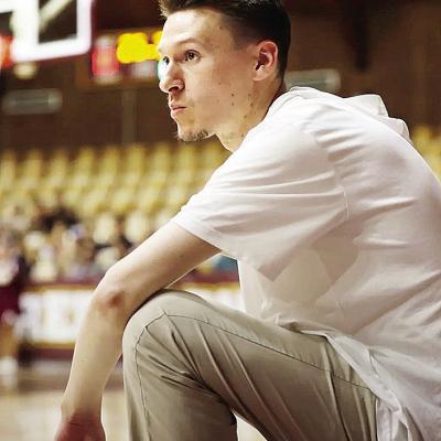 Clinton High School boys’ basketball coach Mark Seiter kneels on the sideline during a game as he focuses on his team in the Tornado Dome. CDN | Courtesy photo