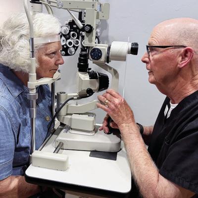 Suzanne Day, left, gets one last eye exam from her husband, Dr. Pat Day. CDN | Shiann Dawson