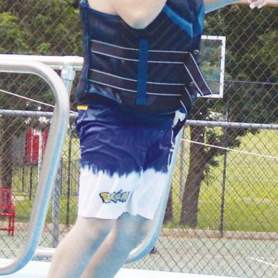 Aiden Perez jumps off of the diving board for the first time ever during Summer Playground at the Clinton Pool. CDN | Christian Jacobsen