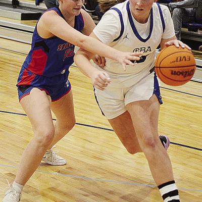 No. 35 Kate Stewart, right, fights to get by her defender during Corn Bible’s win over the Lady Trojans of Sharon-Mutual. CDN | Sam Goodwyn