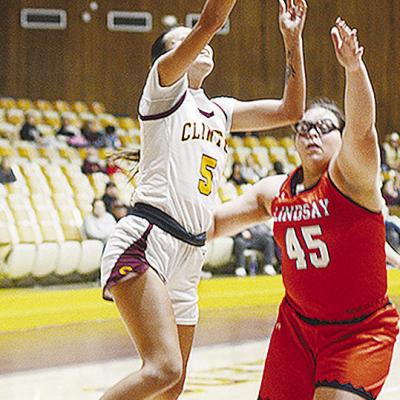 Clinton’s Lillian Lime lays the ball up to the basket over a Lindsay opponent during the Lady Reds’ home opener Saturday against the Leopardettes. CDN | Sam Goodwyn Clinton’s Lillian Lime lays the ball up to the basket over a Lindsay opponent during the Lady Reds’ home opener Saturday against the Leopardettes. CDN | Sam Goodwyn
