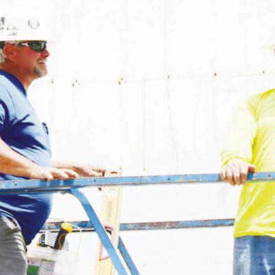 Randy Thomas, left, and Artemio Ponce hammer nails into the framework of the new CMS building, as construction continues at the site. CDN | Elisha Rangel Construction progresses at CMS