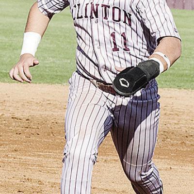 Clinton’s Eli Anderson hustles to third base during the Reds’ home game against El Reno. CDN | Sam Goodwyn