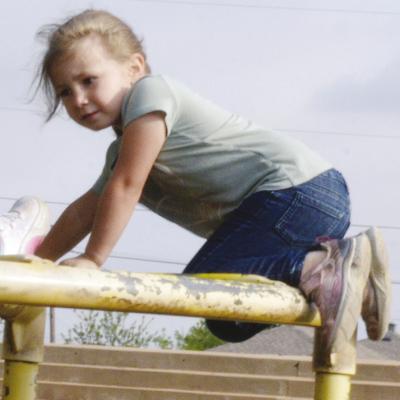 Eden Wright climbs to the top of the monkey bars at Nance Elementary. CDN | Christian Jacobsen