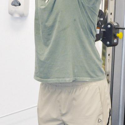 Brooks Red works on his arms by doing tricep extensions at Acme Brick Park weight room. CDN | Christian Jacobsen