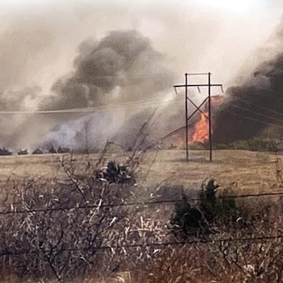 Homesteads near the Dripping Springs area watched wildfires come periously close around noon Sunday thanks to high winds stoking up the blaze. CDN | Courtesy photo