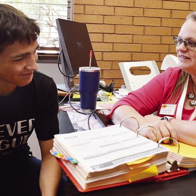 Brycen Farmer, left, and Clinton High School Counselor Casey Perez go over goals for the year in her office Thursday afternoon. CDN | Micah Ashcraft