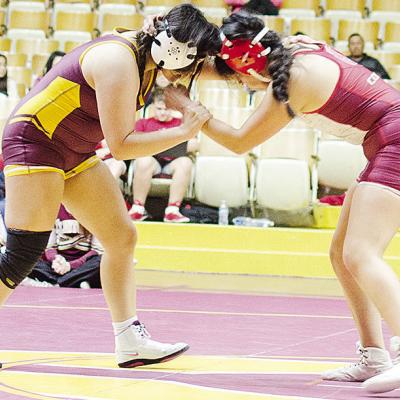 Clinton’s Kassandra Kaline, left, grapples with her opponent from Hinton during the Lady Reds’ home exhibition match with the Lady Comets. CDN | Sam Goodwyn