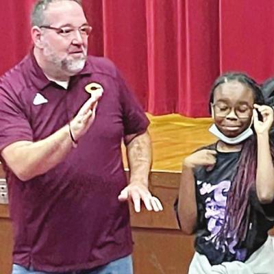 Mike Conn, left, gave a presentation to Clinton Middle School students over good aspects of being a leader, and Elliyah Lowery was one of the students assisting. Middle school working on students’ leadership skills