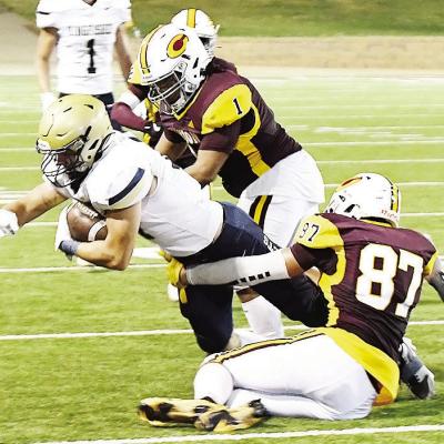 Clinton’s Malachi Lorne, center, and Ethan Lofland, right, take down the Kingfisher ball carrier during the Red Tornadoes’ home-opening win Friday in the Tornado Bowl over the Yellowjackets. CDN | John Kinsey CHS stings Kingfisher in OT