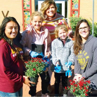 CDN | Robert S. Bryan Getting flowers ready for Monday’s event are, from left, Brittany Crider, Kendall Serfoss, Jordan Mosburg, Maysen Mosburg and Katie Serfoss. Dads to root relationships with flowers