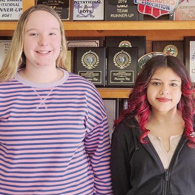 Clinton Middle School Spelling Bee runner-up Carli Patton, left, and winner Melanie Moy stand together after the competition winning word “hypnosis” was spelled. Moy will go on to represent Clinton Middle School at the district level. CDN | Courtesy p
