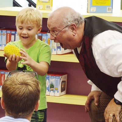 Skeeter Martin, left, is amazed by magician Doc Rogers at the Clinton Public Library’s Summer Reading Program first weekly performance. CDN | Micah Ashcraft