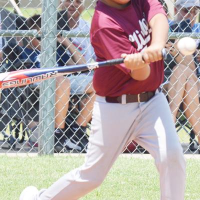Nauko Fletcher swings into the ball during the recent OK Kids 8U Baseball State Tournament at Schumacher Fields at Acme Brick Park. CDN | Sam Goodwyn OB&T's