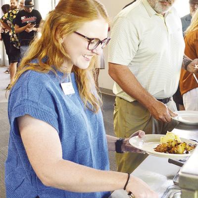 Burgundy Howes grabs a plate while at a Clinton Chamber of Commerce Luncheon recognizing new members held at the Frisco Center. Burgundy Howes grabs a plate while at a Clinton Chamber of Commerce Luncheon recognizing new members held at the Frisco Center.