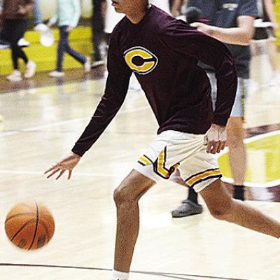 Clinton’s Rufus Whiteman-Ellis dribbles the ball during warmups prior to the Reds recently taking on district foe Elk City in the Tornado Dome. CDN | Sam Goodwyn