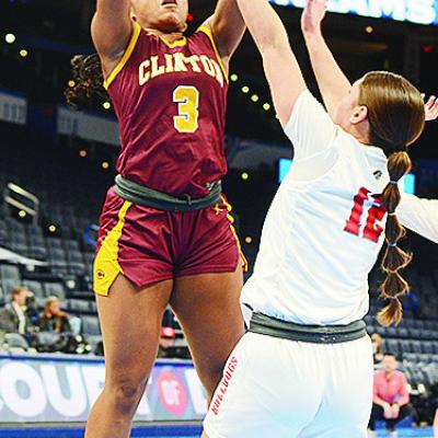 Clinton’s Arlena Kirkendoll shoots the ball over a Cache defender during the Lady Reds’ come-from-behind win over the Lady Bulldogs. CDN | Sam Goodwyn