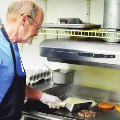 Bruce Lamborn, co-owner at Route 66 Café, keeps a close eye on the grill as he also watches the rising prices of meat. CDN | Collin Wieder Local restaurants hit with high meat prices