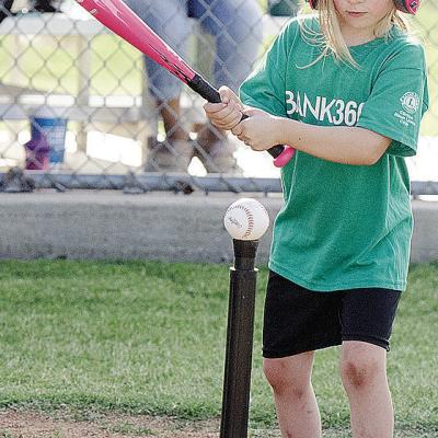 Kezli Cox focuses on the ball as she goes into her swing during her Noon Lion’s Club T-Ball game at Schumacher Fields at Acme Brick Park CDN |Sam Goodwyn