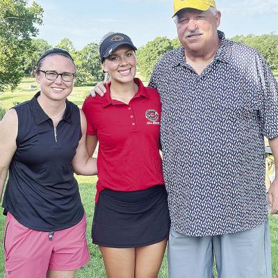 Grace Meacham, center, celebrates her All-State appearance Monday at Cherokee Hills Golf Club in Catoosa with current Clinton Lady Reds’ Golf Coach Tasha Marshall, left, and former golf coach Mike Lee. CDN | Courtesy Photo