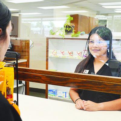 Store Clerk Amy Salazar helps a customer fill their prescription behind the counter at Salisbury Pharmacy. CDN | Micah Ashcraft