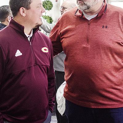 Clinton’s new football coach Trevor Powers, left, talks with Jeff Johnson during the Chamber of Commerce Luncheon Monday at the Frisco Center. CDN | Sam Goodwyn