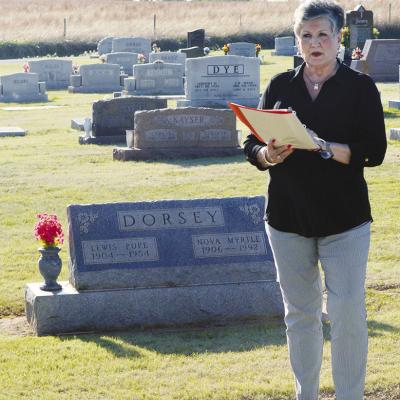 Sharon Meacham stands near the Dorsey family plot as she tells the story of her uncles and their running of the Route 66 Fruit Market Monday evening during the 2026 Spring Cemetery Walk at the Clinton Cemetery. CDN | Christian Jacobsen