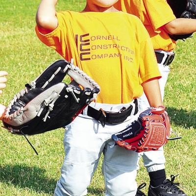 Cal Adams pulls his arm back as he prepares to throw the ball during warmups prior to one of his Noon Lions Club T-Ball games. CDN | Sam Goodwyn