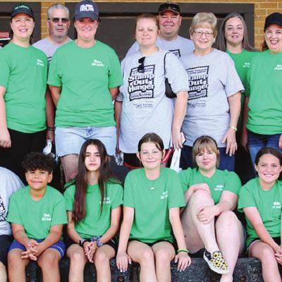 U.S. Postal workers and scouts from Girl Scout Troops 212 and 510 teamed together for Saturday’s food drive. Pictured front, from left, are Enamore Jones, Dezhanae Simmons, Rosa Flores, Darius Southerland, Adrean Rodriquez, Kalyssa Staggs, Rossalyn Simp Food drive collects for needy
