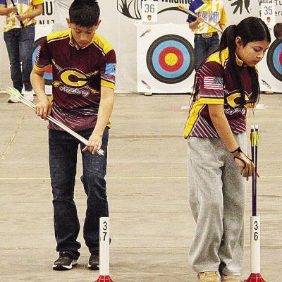 Clinton seventh-graders Caleb Lopez, left, and Hayda Jimenez-Ramos set up their arrows during Grand State Archery last week in Tulsa. CDN | Courtesy photo