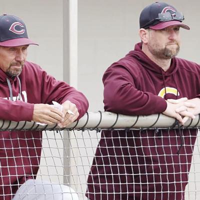 Clinton’s longtime baseball coach Kelly Gaunt, left, and assistant coach Jeff King watch during a baseball game. CDN | Steve Wheeler