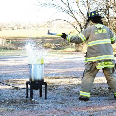 Clinton Firefighter Billy Gerstenkorn and Capt. Blake Shaddon back away after they drop a frozen turkey into a fryer and flames spring up. They did this in order to show the community why frozen turkeys should not be fried. Thanksgiving food prep safety