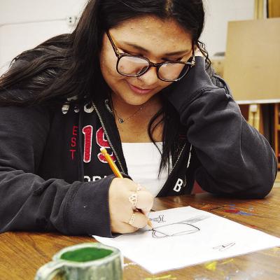 CHS sophomore Analy Venegas sketches a still life of a mug during her art class at Clinton High School. CDN | Micah Ashcraft