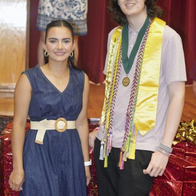 Idalia Pelayo Uribe, left, and Jackson McCullough were named the Red Tornado Boy and Girl of the Year Thursday night at the Senior Awards Ceremony. The packages behind them hold a minirefrigerator for their future dorm room. CDN | Christian Jacobsen