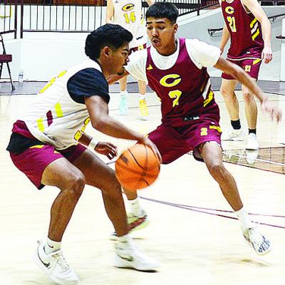 Clinton’s Adam Flores, left, dribbles around teammate Ronnie Redshin during a recent practice in the Tornado Dome. CDN |Sam Goodwyn