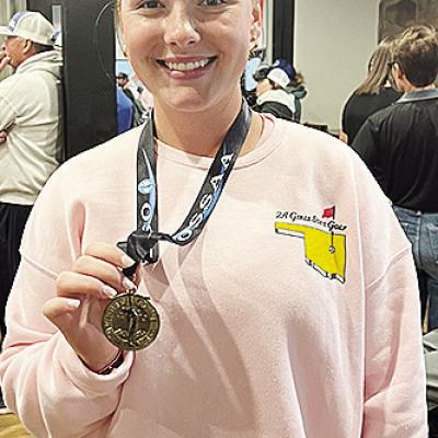 Corn Bible Academy’s Bentli Whitson shows off her medal after finishing ninth at the Class 2A State Tournament at Muskogee Country Club. CDN | Courtesy photo