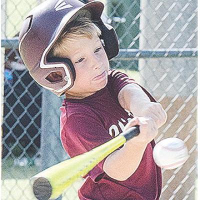 Clinton’s Timmy Sorter puts all of his strength behind his swing during the Reds’ first-round game of the OK Kids 8U Baseball State Tournament Thursday at Schumacher Fields at Acme Brick Park. CDN | Sam Goodwyn