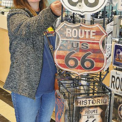 Kimberly Warner of Meers looks at the Route 66 signs Wednesday in the gift shop of the Oklahoma Route 66 Museum. CDN | Sam Goodwyn