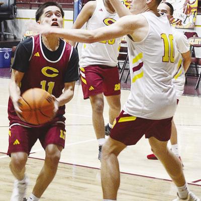 Clinton’s AJ Reynolds, left, fights through teammate Parker Adams on his way to the basket during practice in the Tornado Dome. CDN | Sam Goodwyn