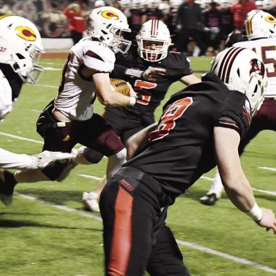 No. 10 Cooper Sulley rumbles up the field seeking to avoid Poteau’s No. 5 Jagger Dodson with Clinton’s No. 37 Parish Blackwolf and No. 15 Trey Bennett looking to make blocks against the Pirates. CDN | John Kinsey Reds’ season ends in 3OT-loss