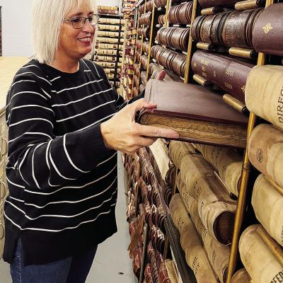 Custer County Clerk Melissa Graham pulls from the records in the Custer County Archives, housed in the former county jail after recent renovation, at the Custer County Courthouse. CDN | Shiann Dawson