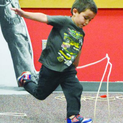 Sully Acosta winds up a spin to get his lasso to move faster than he previously did, at the Clinton Public Library.