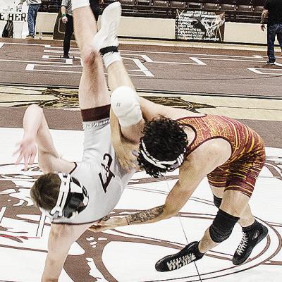 Clinton’s Tristan Cardenas, right, throws his opponent to the mat during the District Duals in Elk City. CDN | Sam Goodwyn