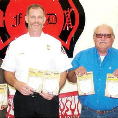 With the donated smoke alarms are, from left Mindy Moore, Tammy Shepherd, CFD Chief Brett Russell, Allen Shepherd and CFD Lt. Caleb Moore. Clinton Fire Department has smoke alarms available