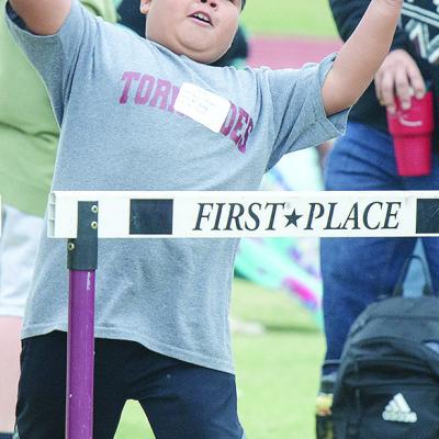 Alan Vinaja throws the softball Tuesday during Little Olympics at Clinton High School. CDN |Sam Goodwyn