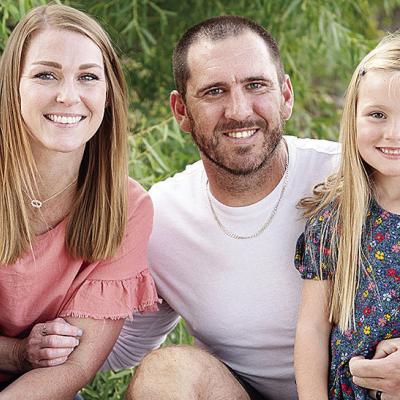 New Clinton Defensive Coordinator Skylar Watson, center, smiles with his wife Jannie, left, and daughter Journey, right. CDN | Courtesy photo