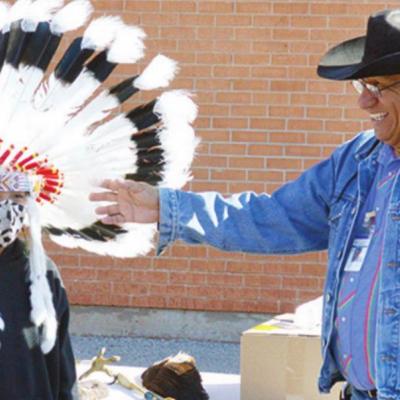 Arapaho Coordinator of Language and Culture Fred Mosqueda discusses Cheyenne-Arapaho tribe traditions with third grader Juan Hernandez. C&A Tribes promote Native American awareness at schools